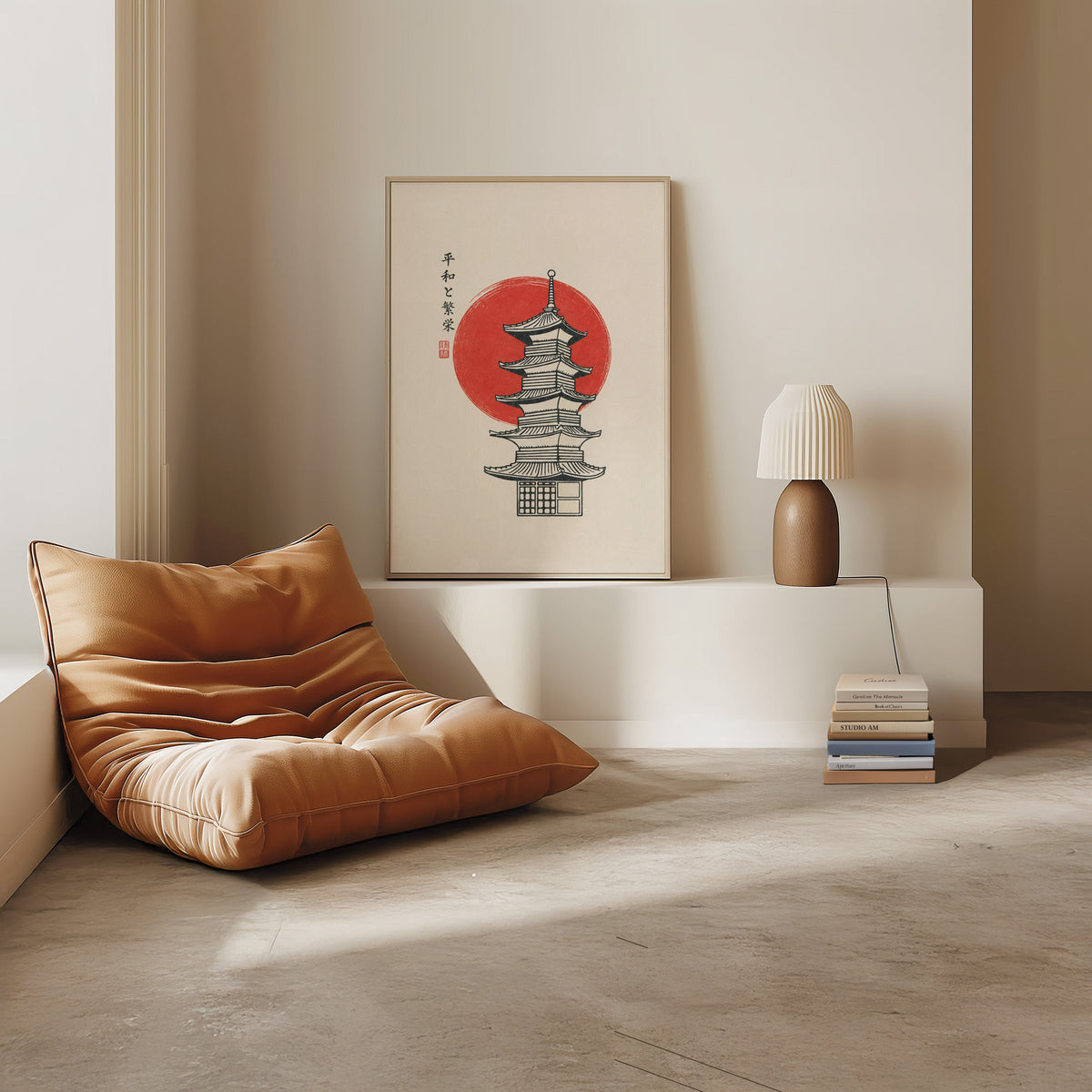 pagoda line art with red sun print in a light oak frame on a white ledge by a tan leather floor chair