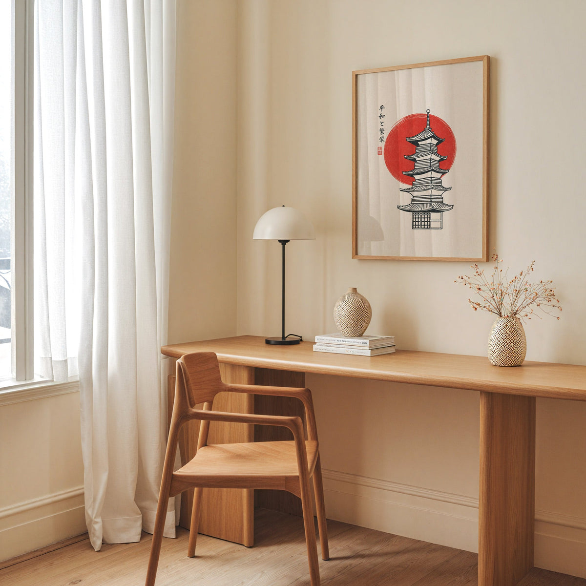 pagoda line art with red sun print in an oak frame above a long oak desk with a white dome lamp and woven vases