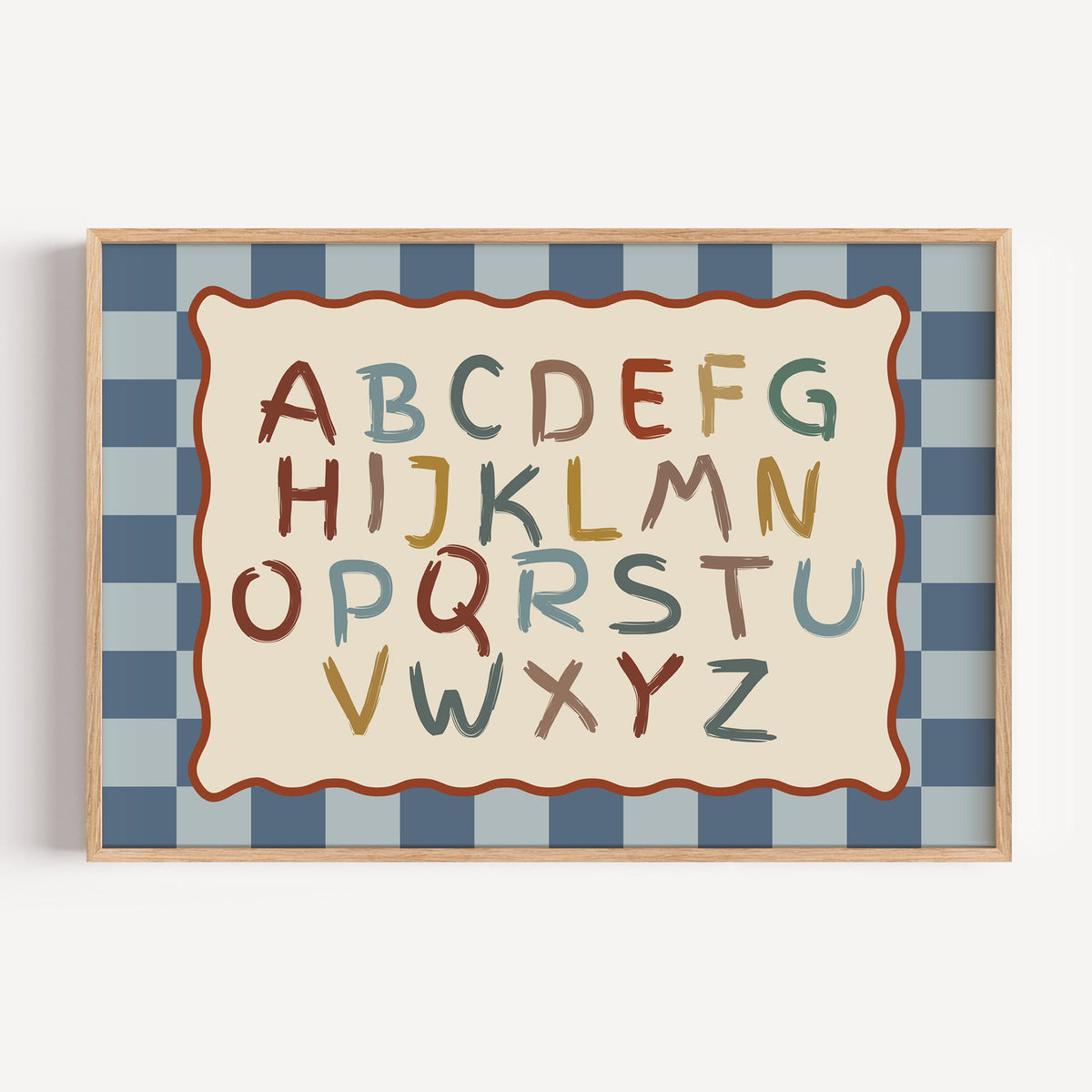 Landscape painted alphabet wavy frame nursery print in a light oak frame on a plain white wall