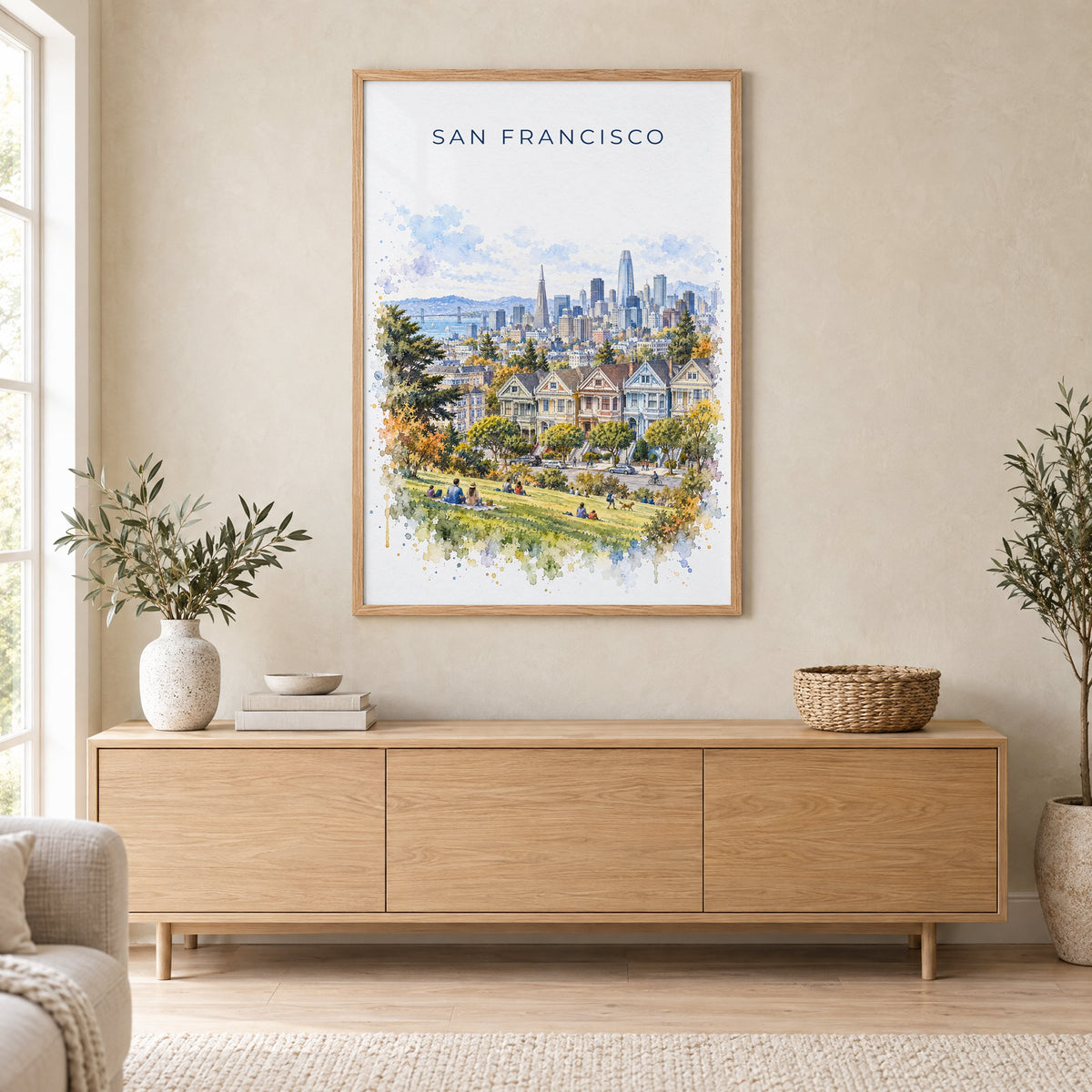 Painted Ladies San Francisco watercolor print in an oak frame above a light wood sideboard in a Scandinavian living room