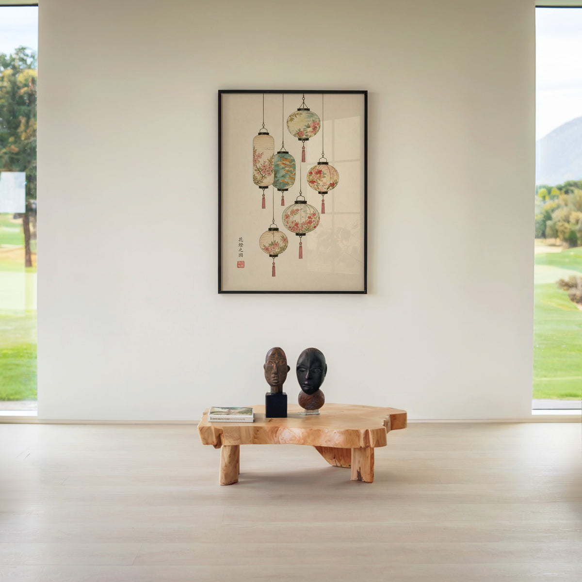 painted paper lanterns with flowers print in a black frame above a live-edge wood coffee table between garden windows