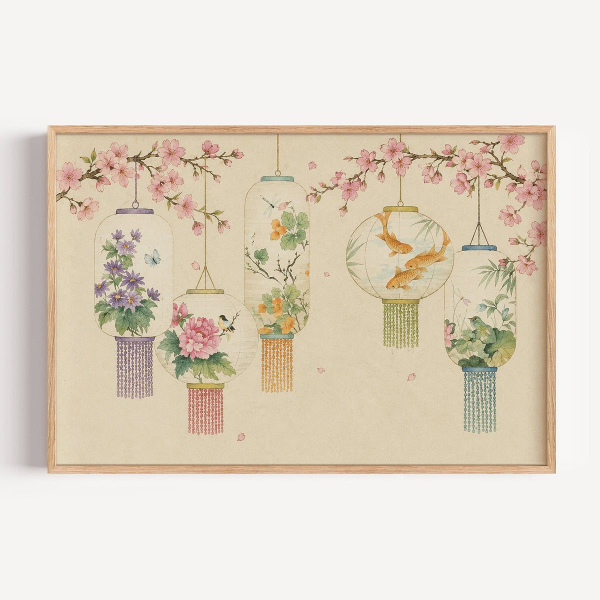 Five painted lanterns under cherry blossom print in a light oak frame on a plain white wall