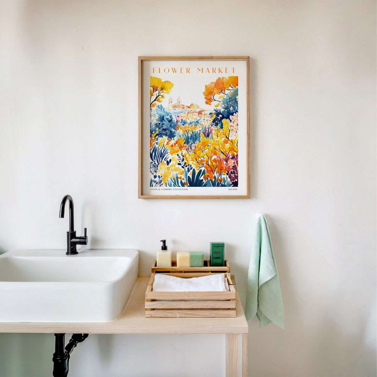 Palermo flower market print in an oak frame above a white bathroom sink with folded towels