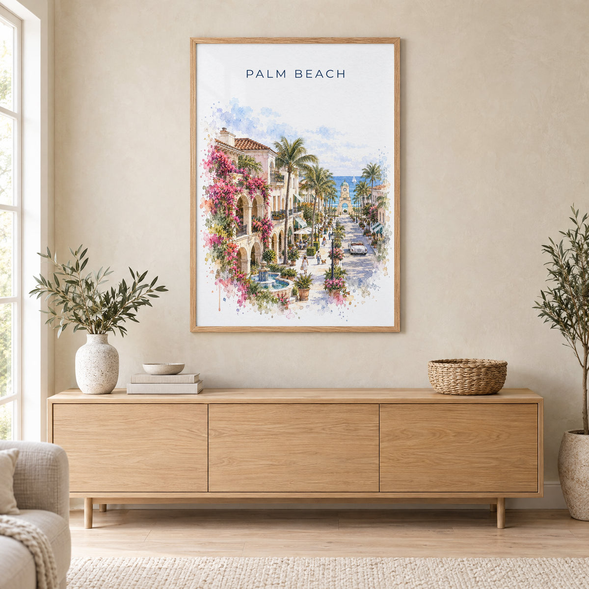 Palm Beach, Florida watercolor print in an oak frame above a light wood sideboard in a Scandinavian living room