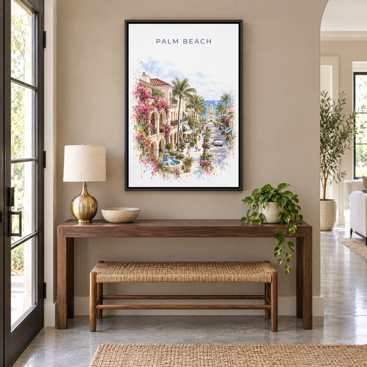 Palm Beach, Florida watercolor print as a black floater canvas above a walnut console and woven bench in an entryway