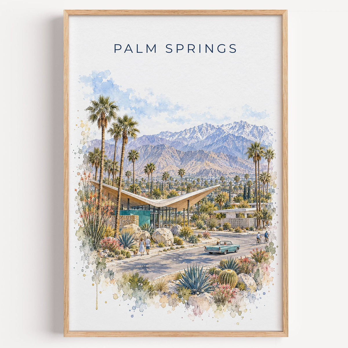 Palm Springs watercolor print in a light oak frame on a plain white wall