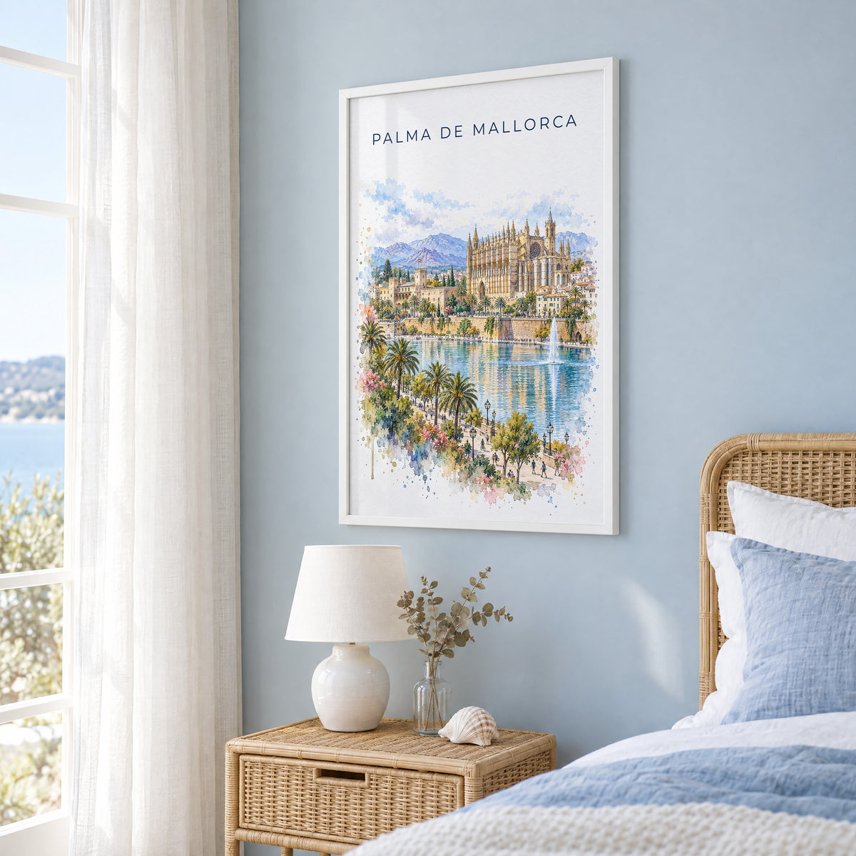 Palma de Mallorca watercolor print in a white frame on a pale blue wall beside a rattan bed in a coastal bedroom