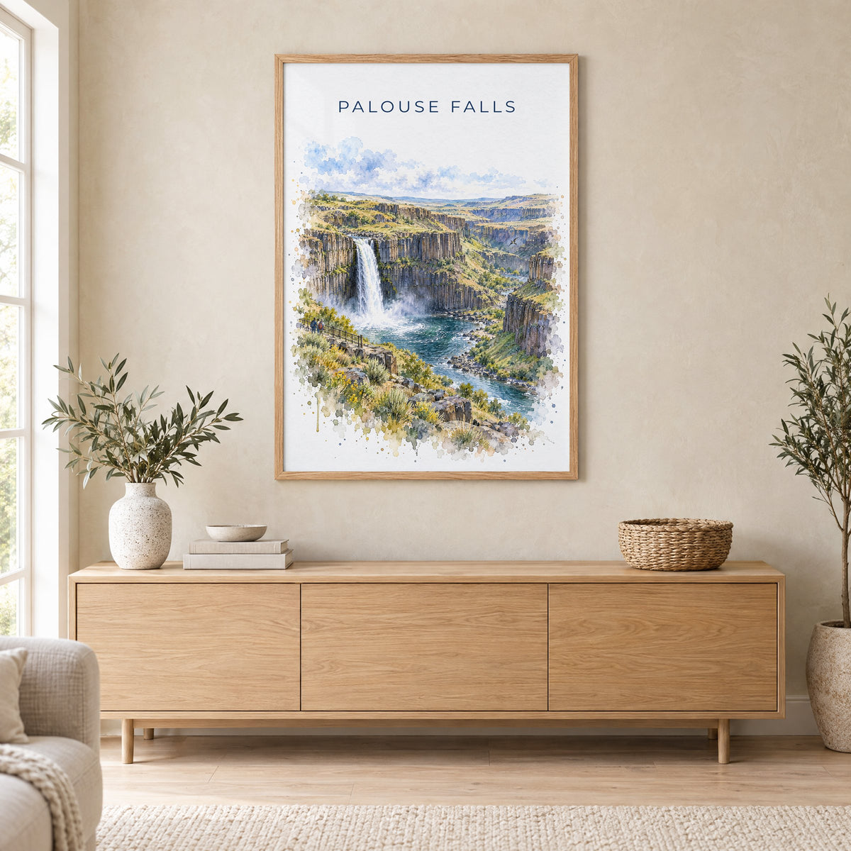 Palouse Falls watercolor print in an oak frame above a light wood sideboard in a Scandinavian living room