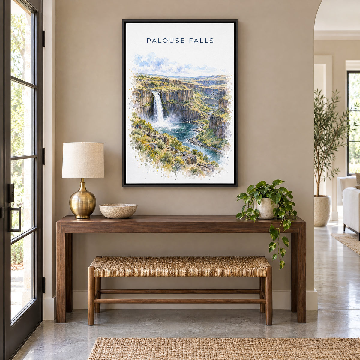 Palouse Falls watercolor print as a black floater canvas above a walnut console and woven bench in an entryway