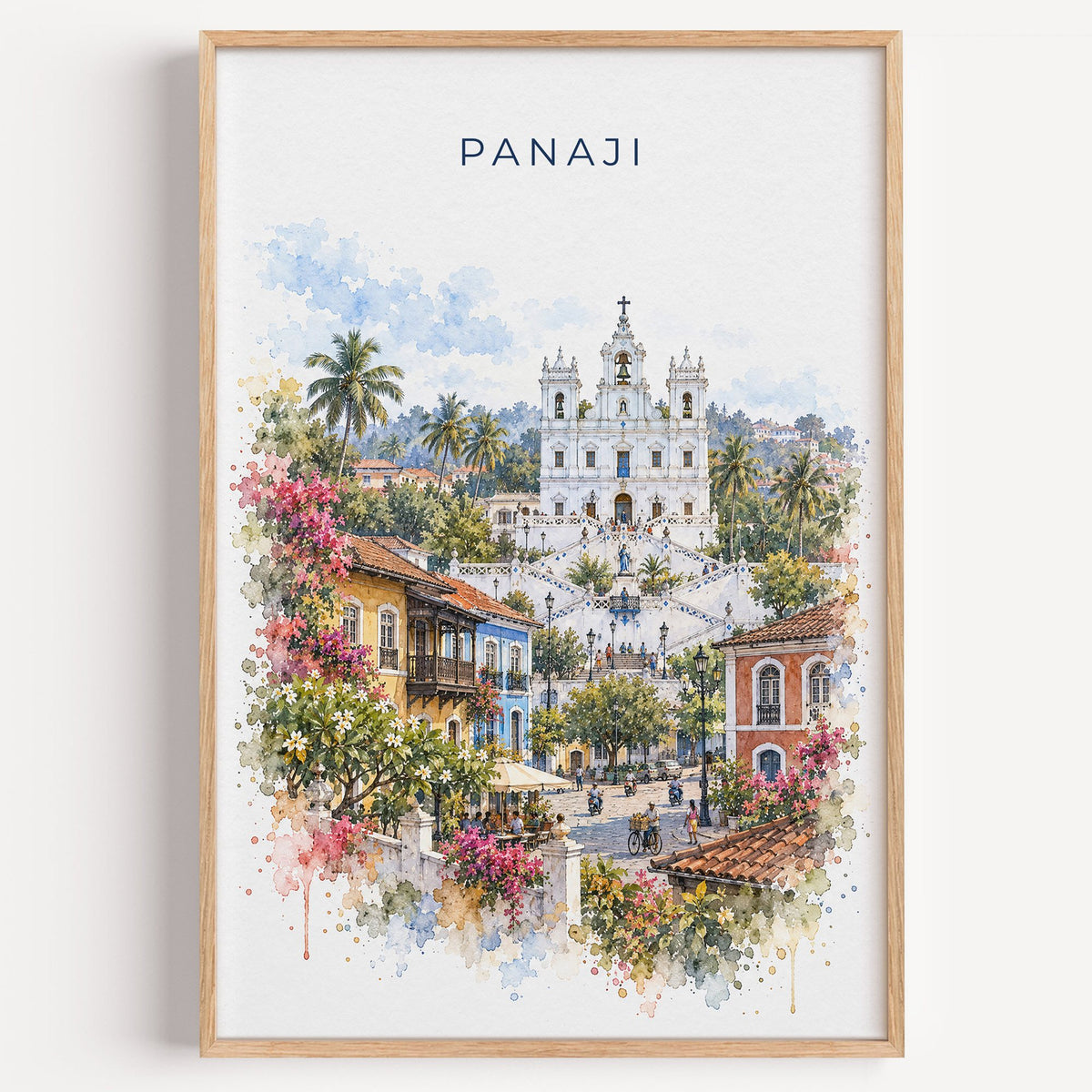 Panaji watercolor print in a light oak frame on a plain white wall
