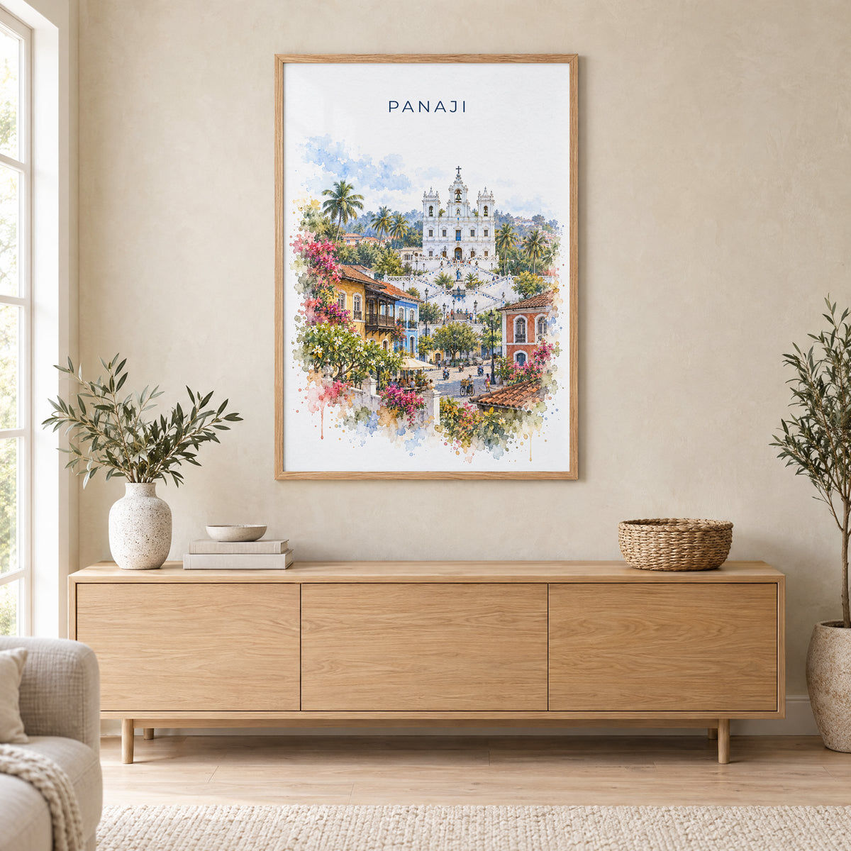 Panaji watercolor print in an oak frame above a light wood sideboard in a Scandinavian living room