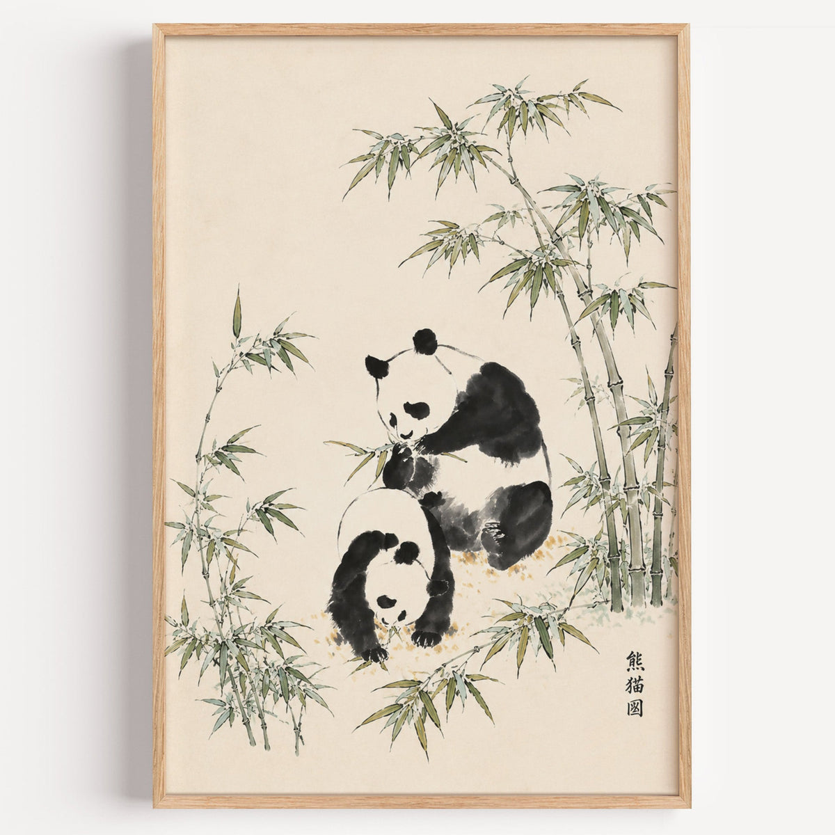 two pandas with bamboo ink painting print in a light oak frame on a plain white wall
