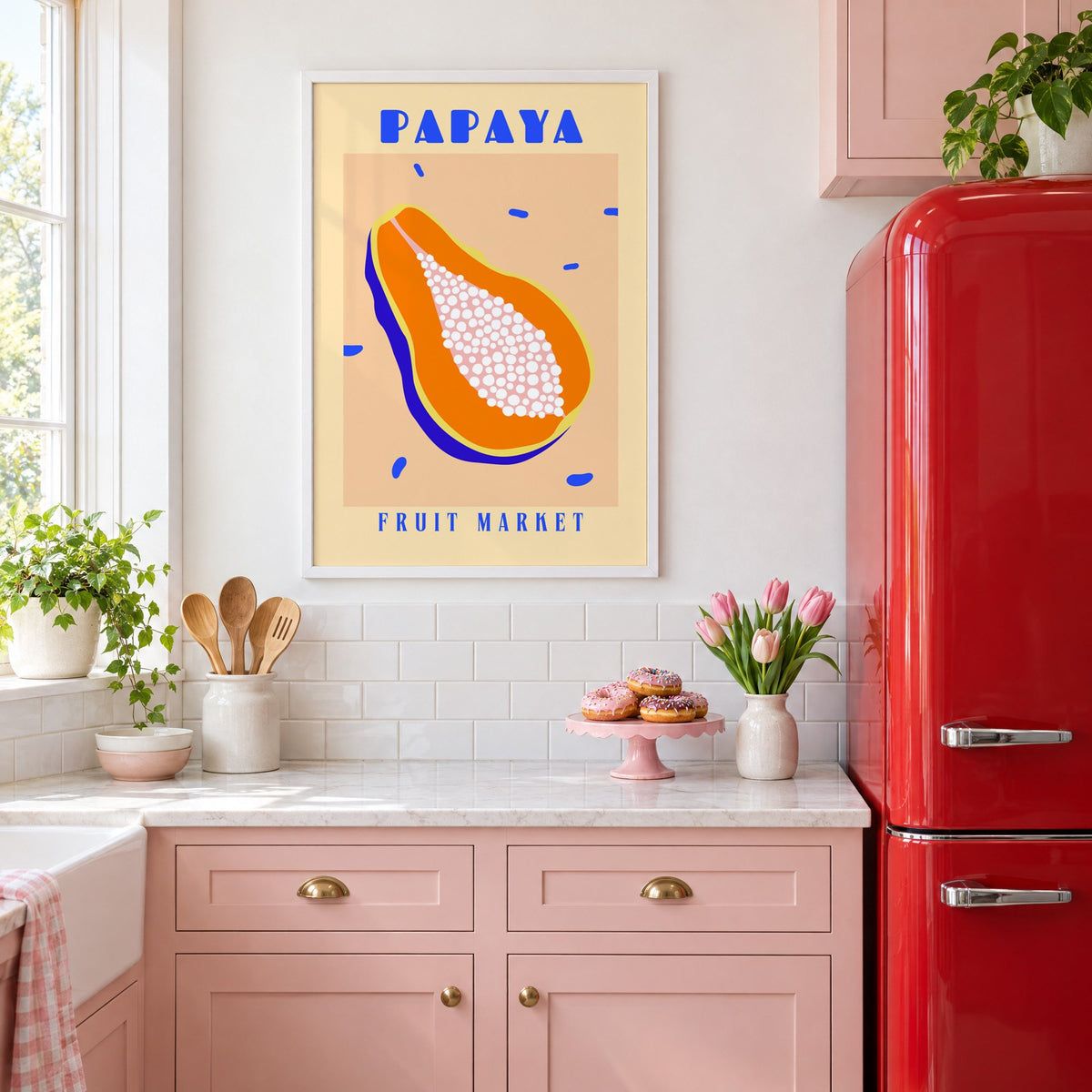 Papaya Fruit Market print in a white frame in a pink kitchen beside a red retro fridge