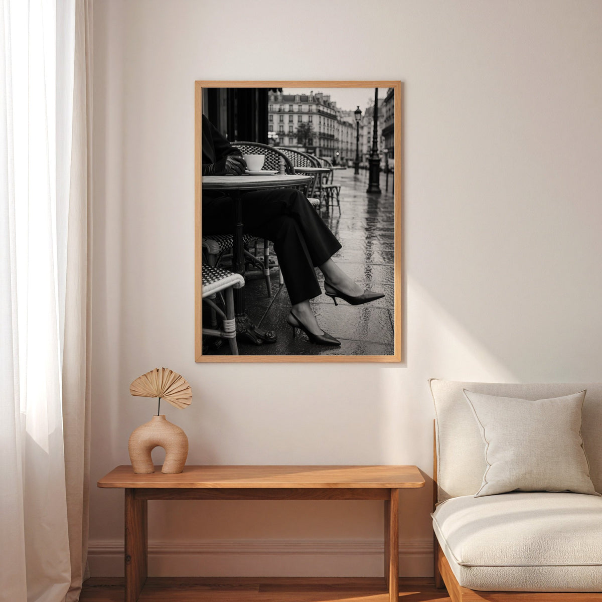 Black heels at rainy Paris café table print in an oak frame above a narrow console with an arched vase