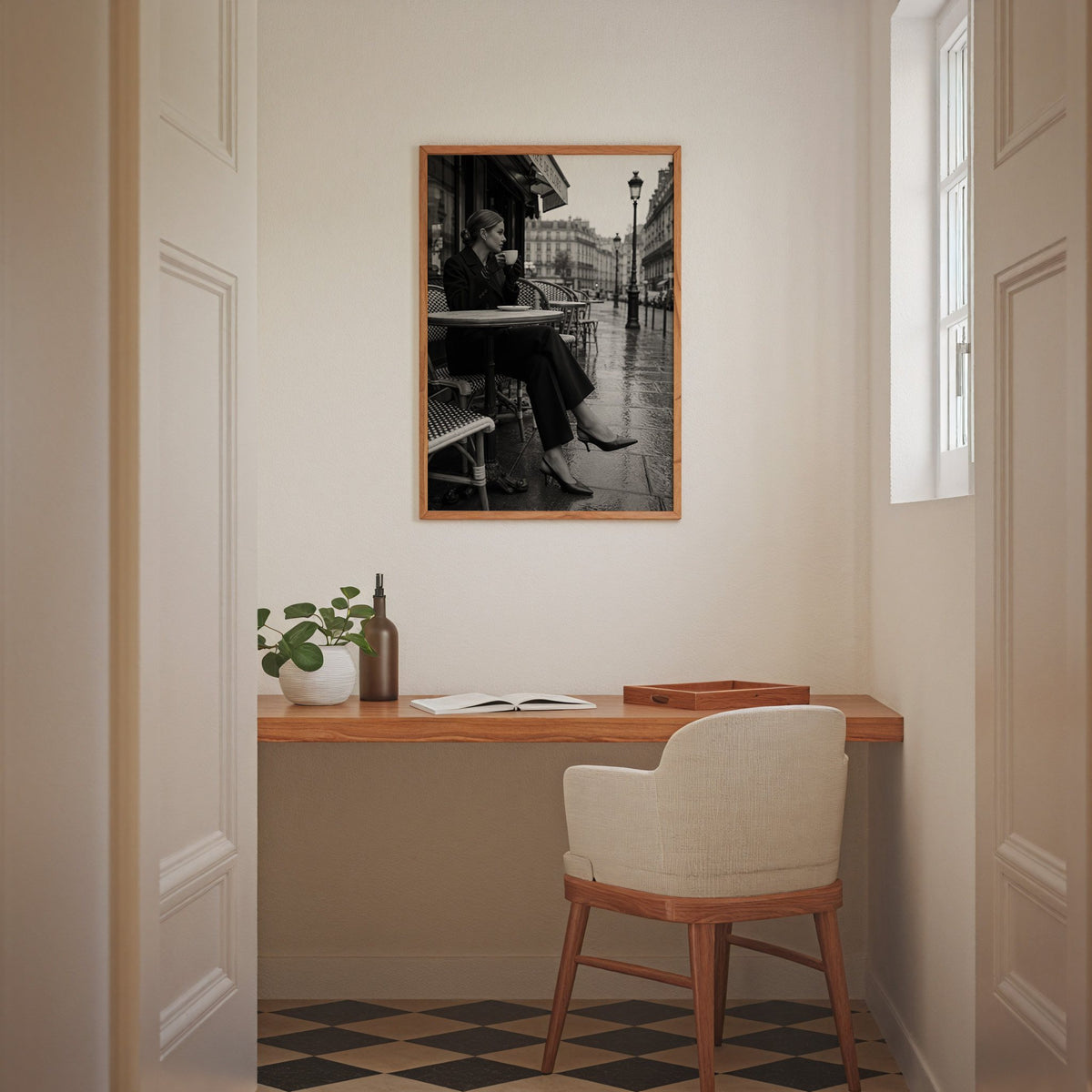 Black and white Paris cafe woman with coffee print in an oak frame above a home office desk nook