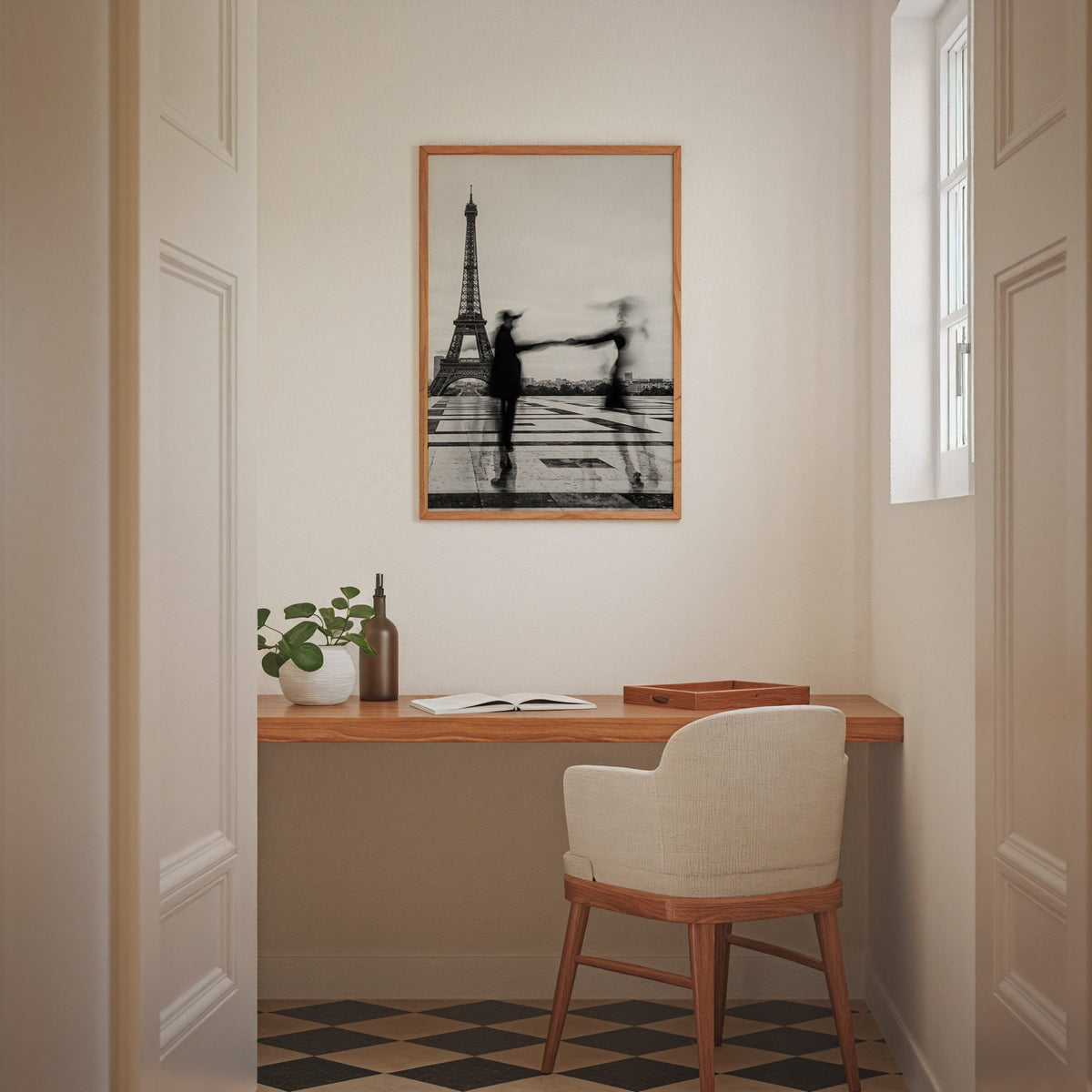 Blurred couple twirling near the Eiffel Tower print in an oak frame above a home office desk nook