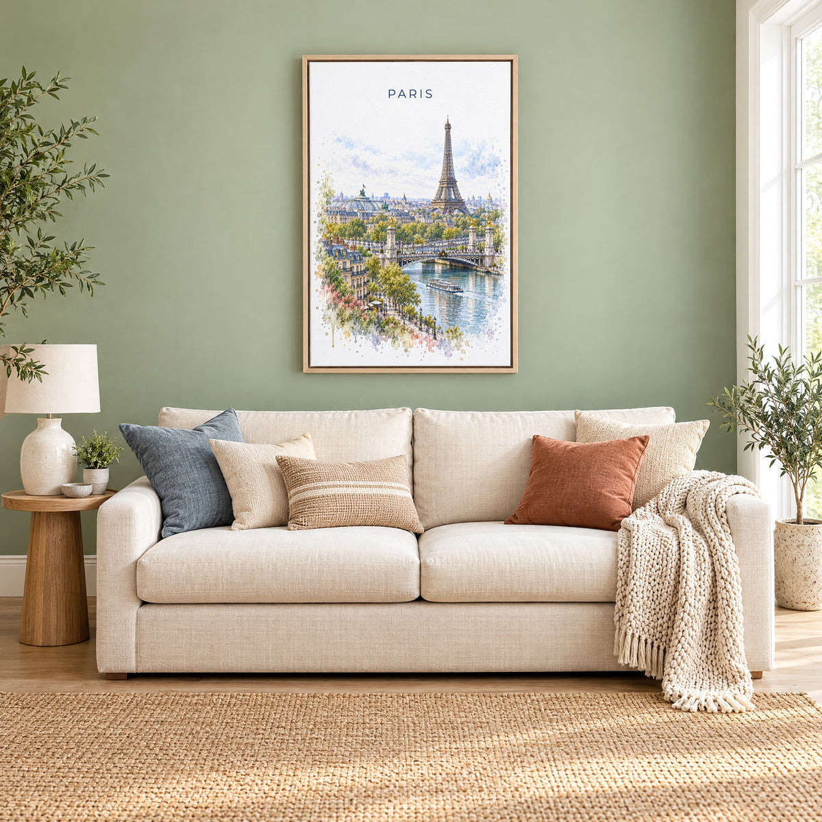 Paris watercolor print as a natural floater canvas above a cream linen sofa on a sage green wall