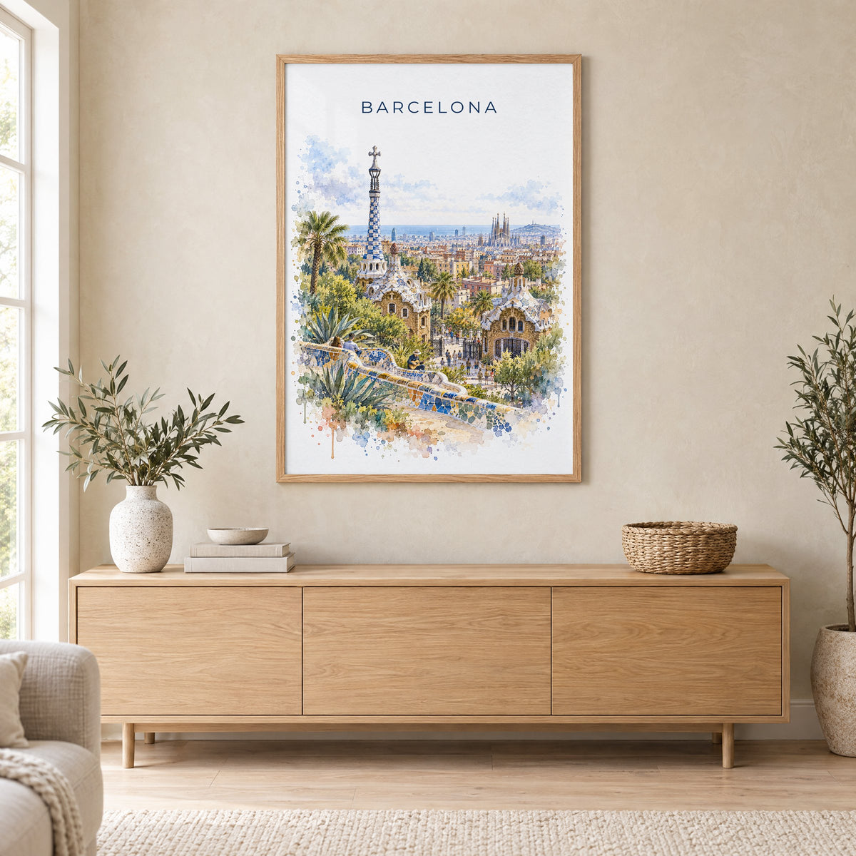 Park Güell watercolor print in an oak frame above a light wood sideboard in a Scandinavian living room