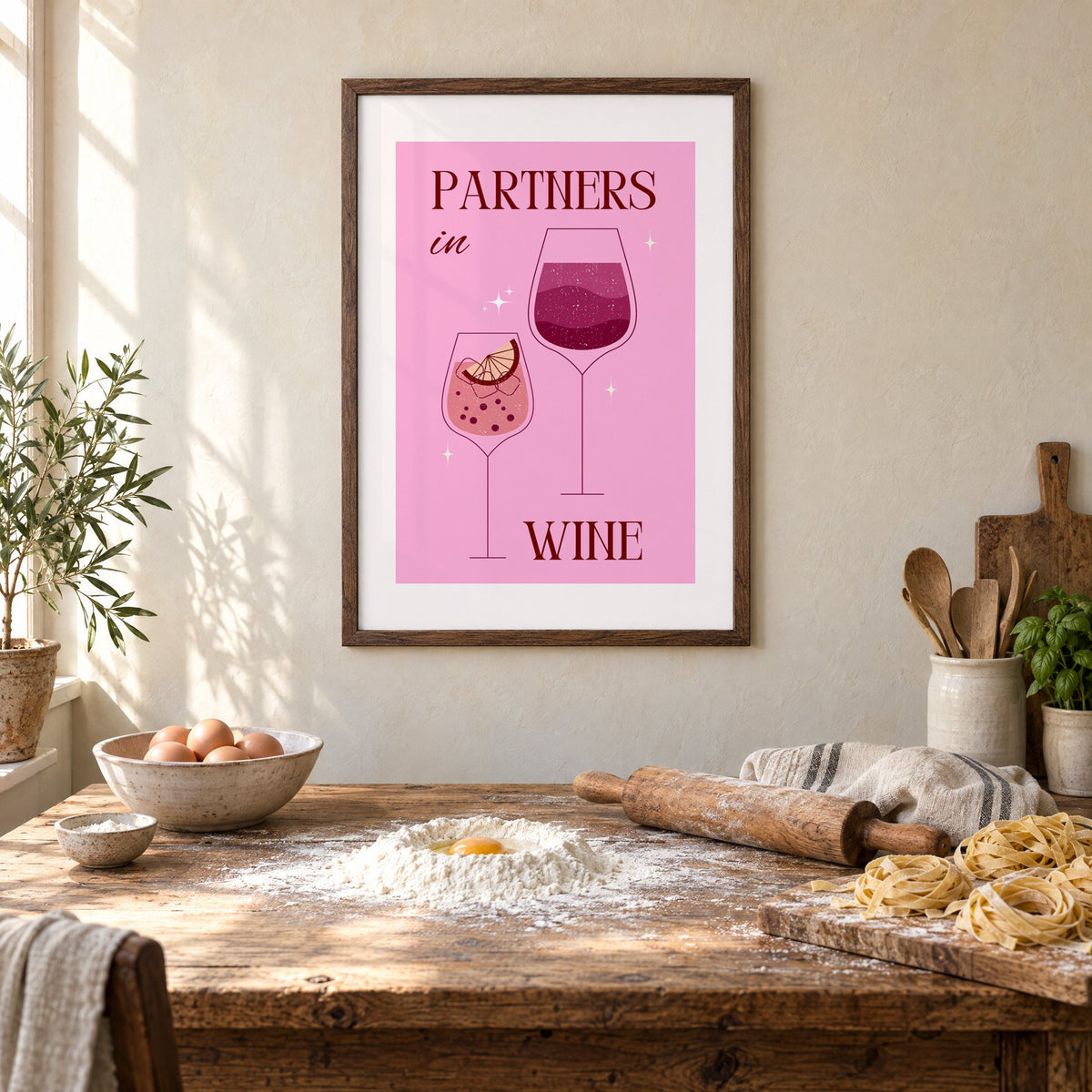 Partners in Wine two glasses pink print in a walnut frame above a rustic table set for making fresh pasta
