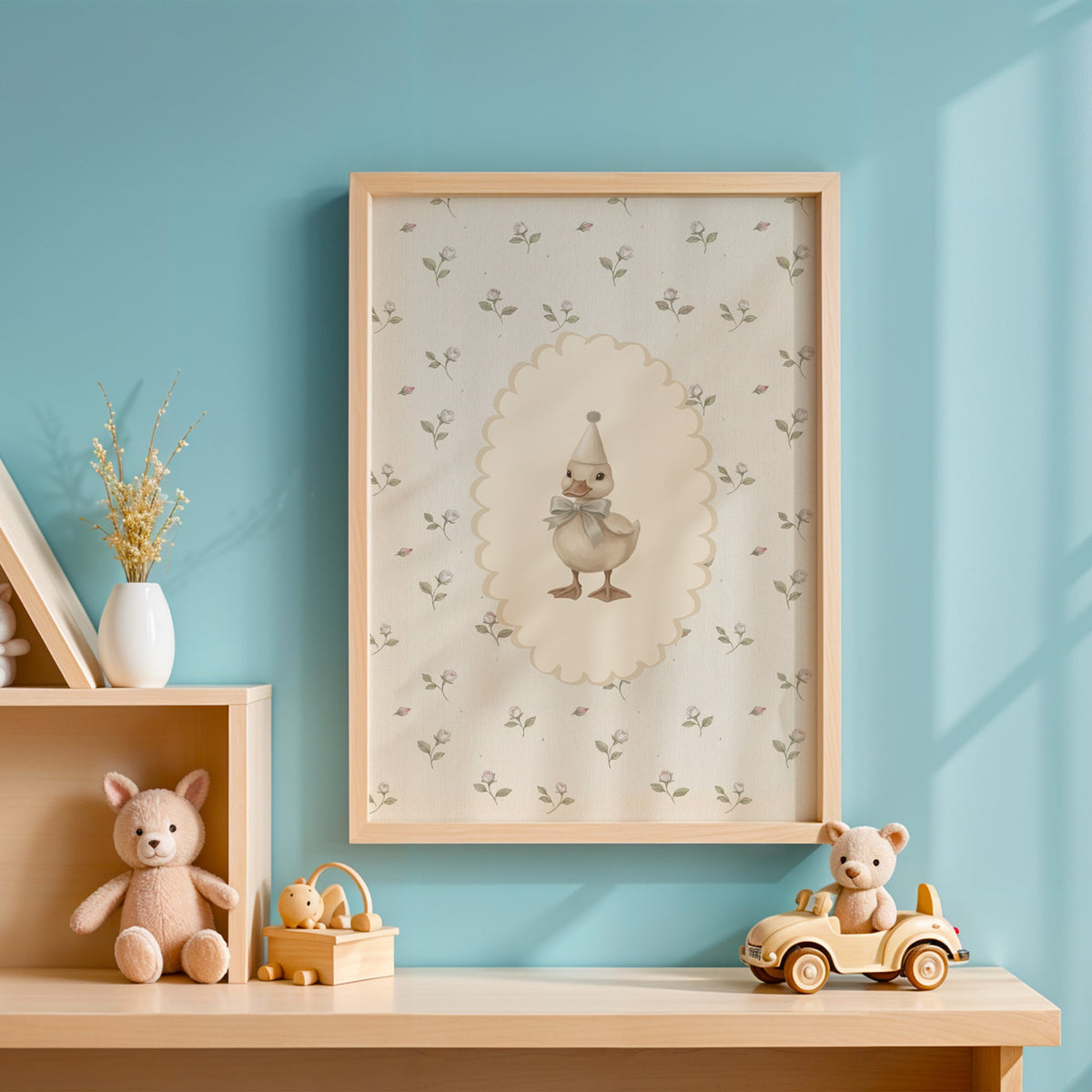 Party duckling in cream oval on rosebuds nursery print in an oak frame on a blue wall above a shelf of wooden toys