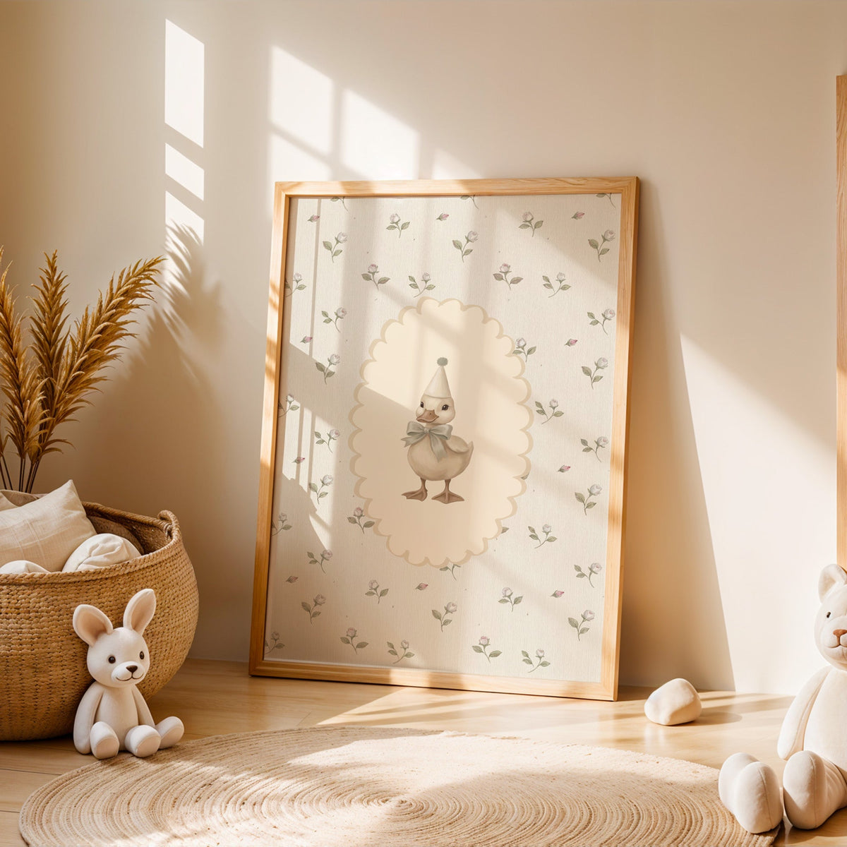 Party duckling in cream oval on rosebuds nursery print in an oak frame leaning on a sunlit floor by a woven basket