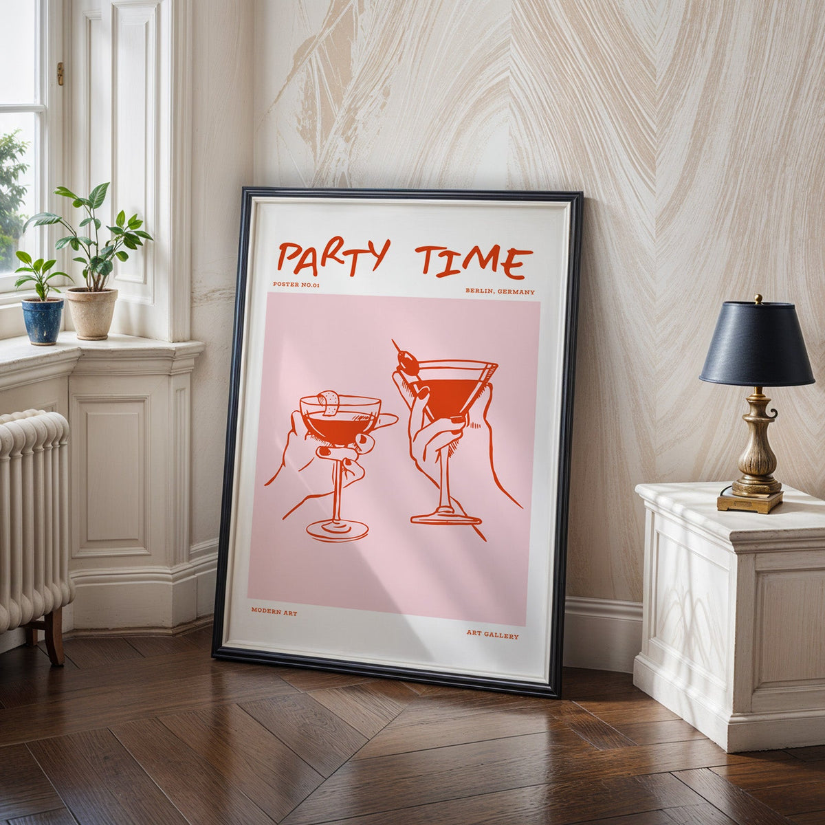 Party Time cocktail toast print in a black frame on a dark herringbone floor