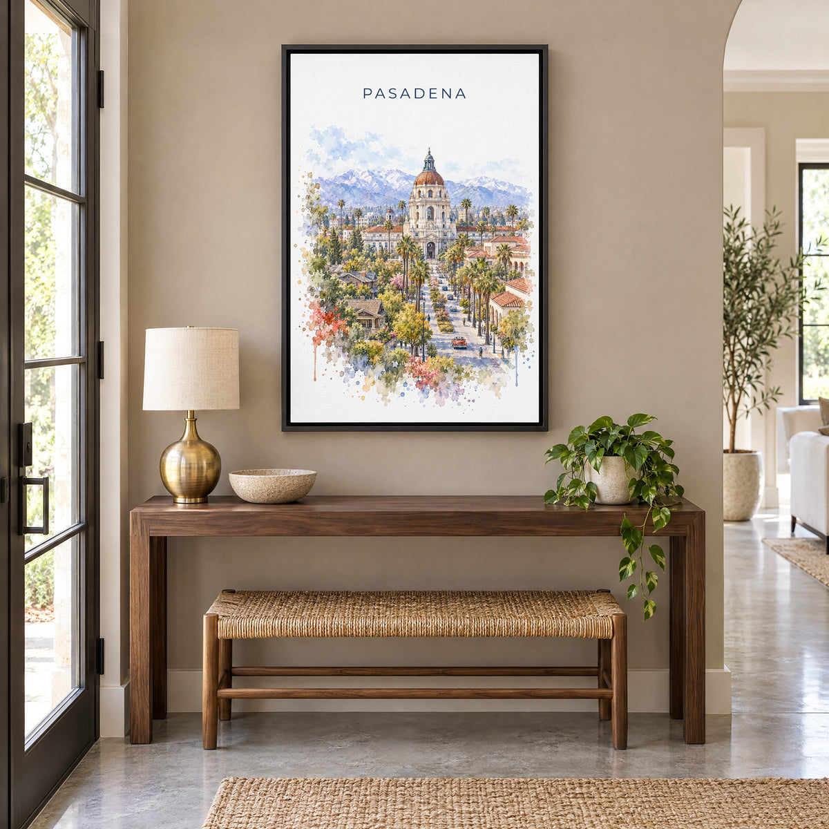 Pasadena watercolor print as a black floater canvas above a walnut console and woven bench in an entryway