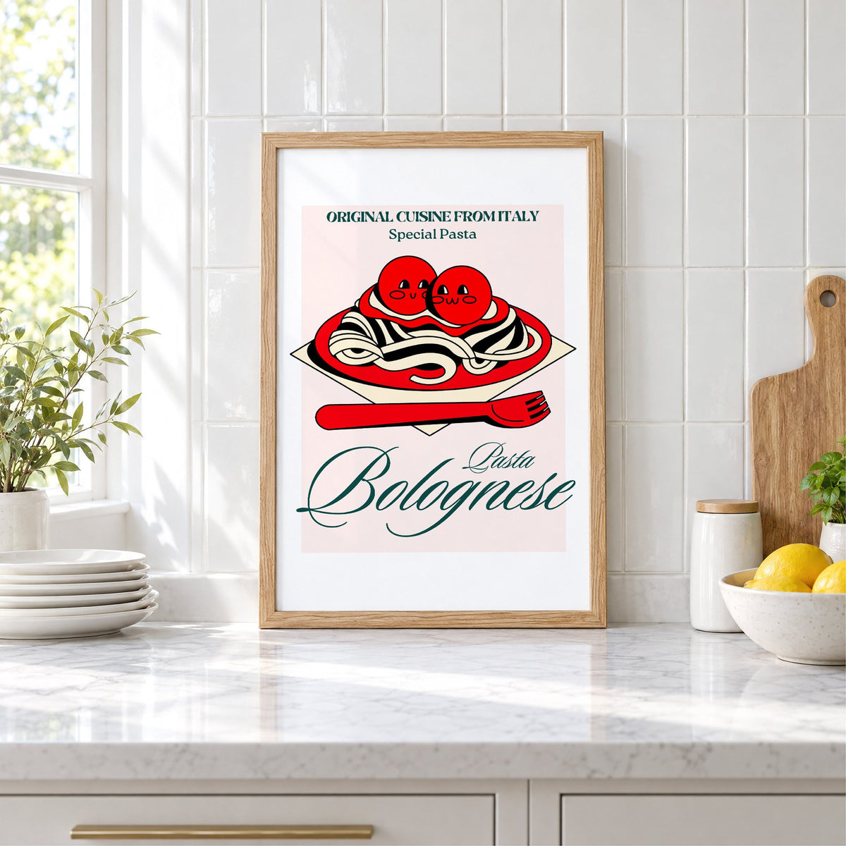 Pasta Bolognese smiling meatballs print in an oak frame leaning on a marble counter by white tiles and lemons