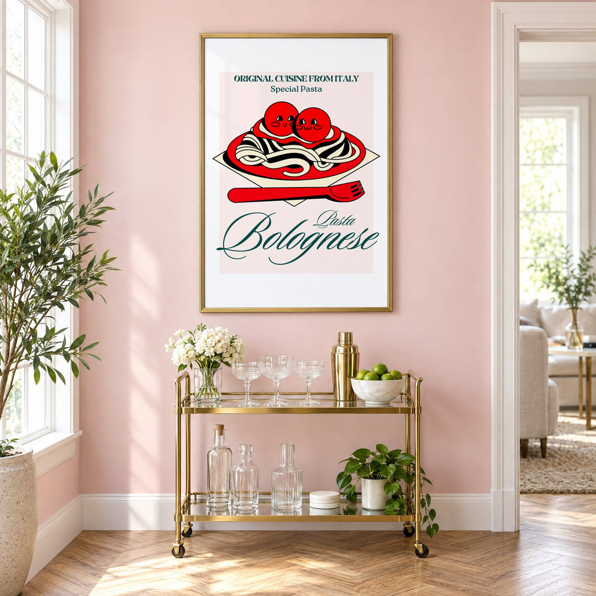 Pasta Bolognese smiling meatballs print in a brass frame above a gold bar cart on a blush pink wall