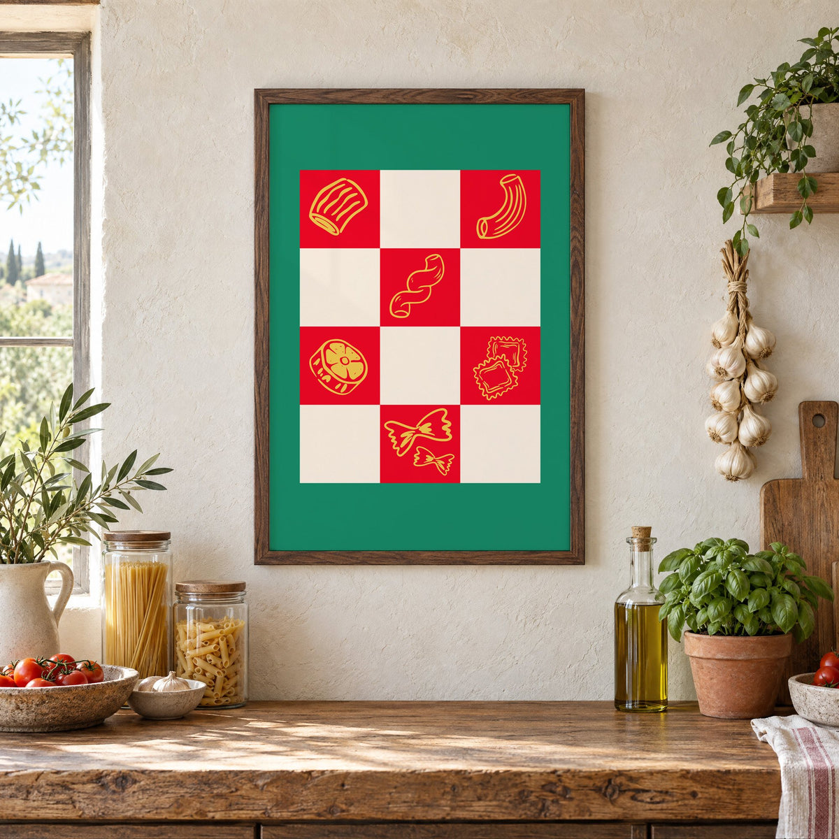Red checkerboard pasta shapes print with green border in a walnut frame above a rustic Italian pantry counter with pasta jars, garlic and tomatoes