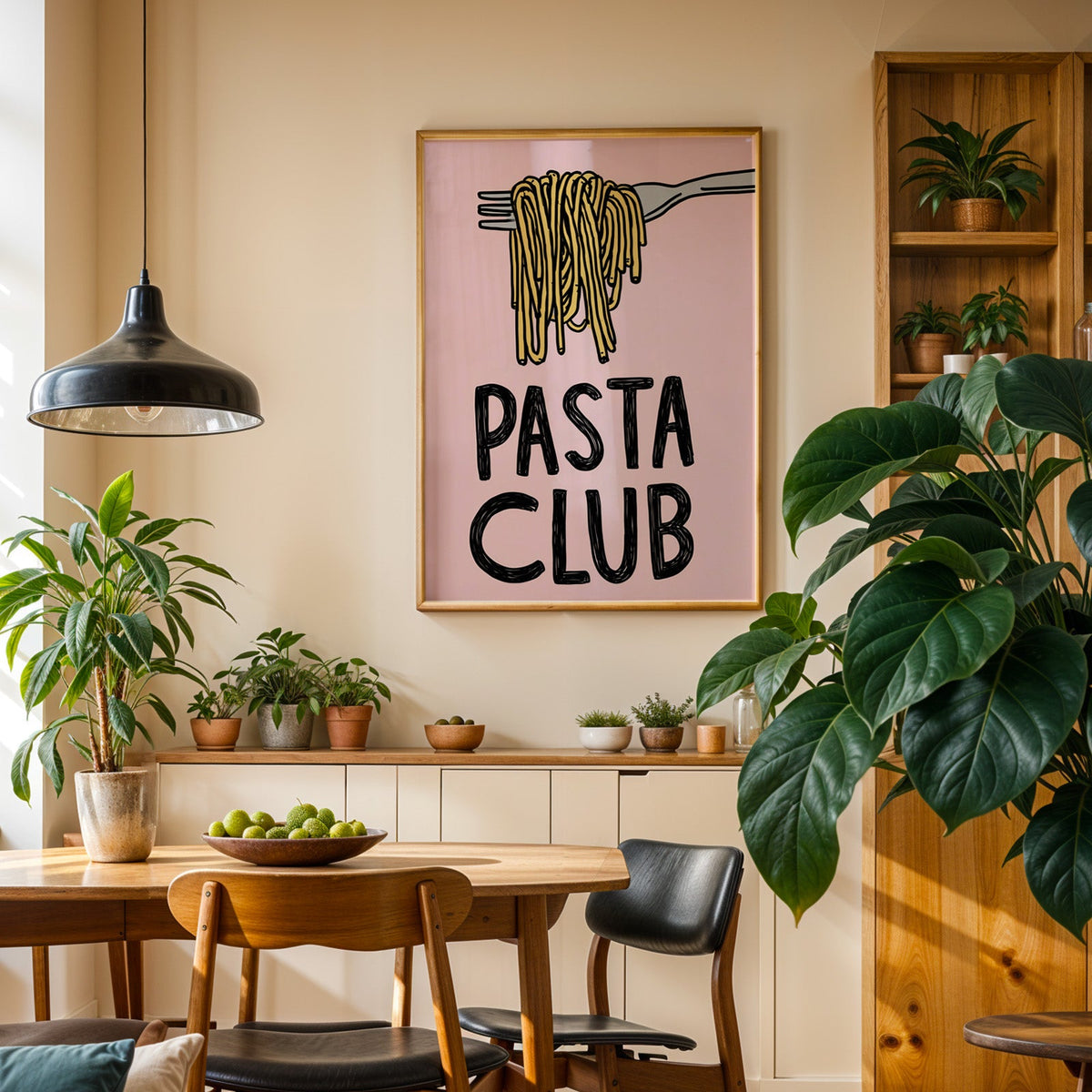 Pasta Club print in an oak frame in a dining room above a plant-lined sideboard