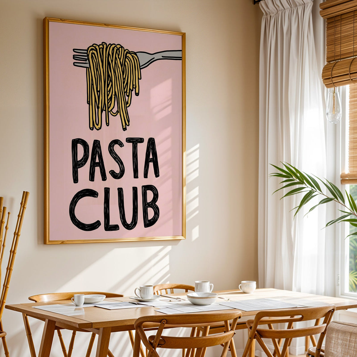 Pasta Club print shown in a gold frame above a breakfast table by a curtained window