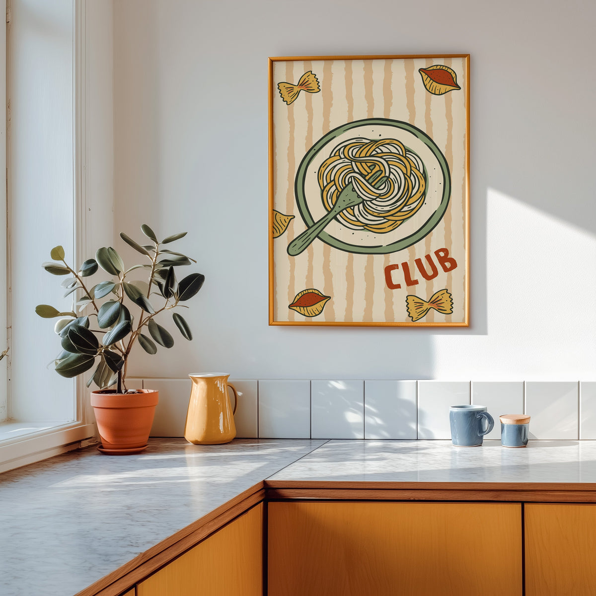 Pasta Club print in a gold frame above a marble counter with a yellow ceramic jug