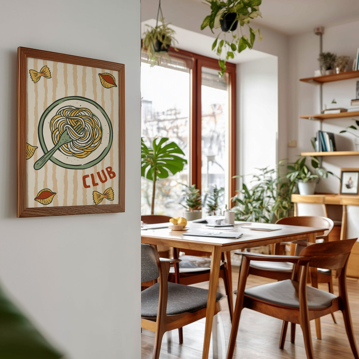 Pasta Club print in a walnut frame beside a mid-century dining table