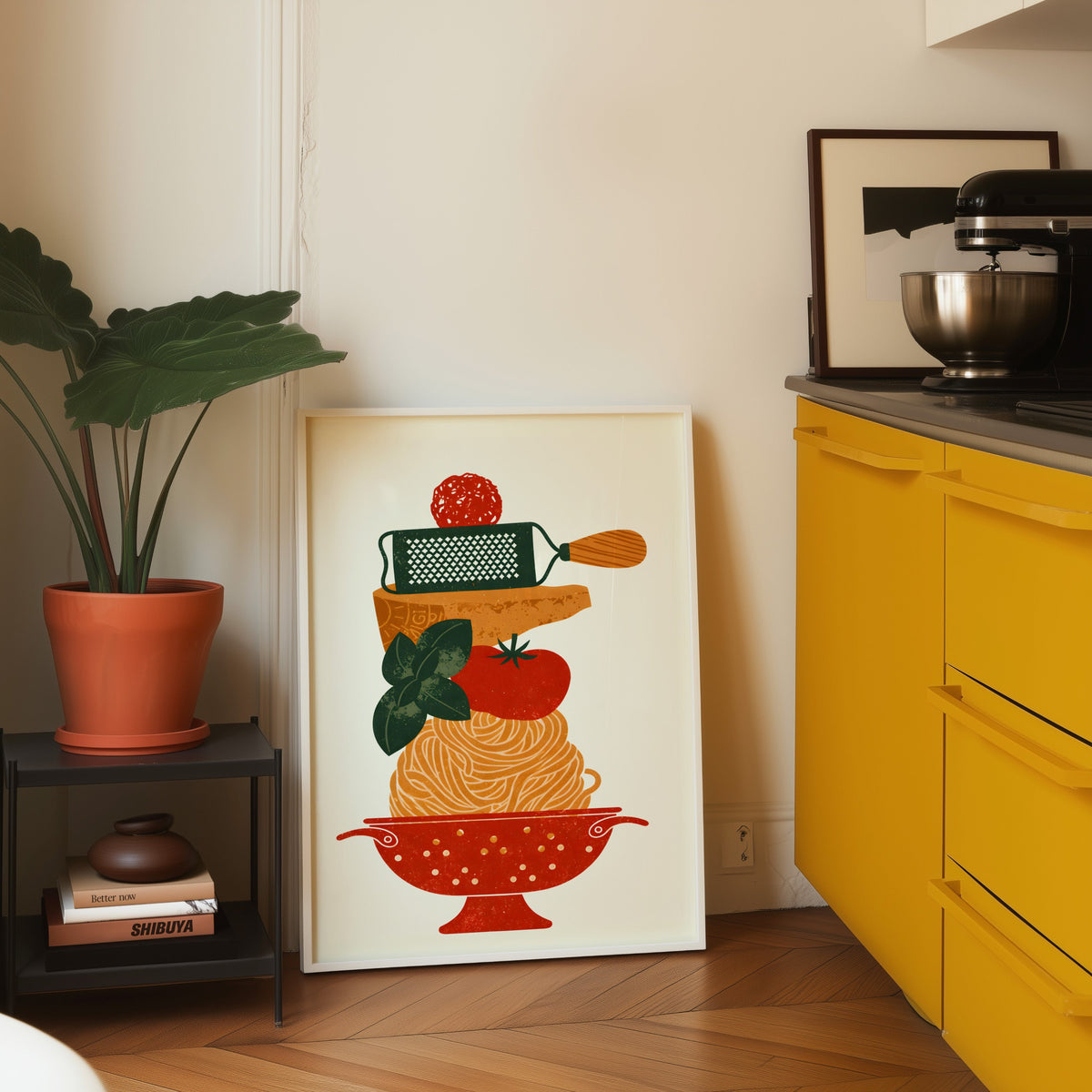 Pasta colander print in a white frame on parquet beside a bright yellow kitchen