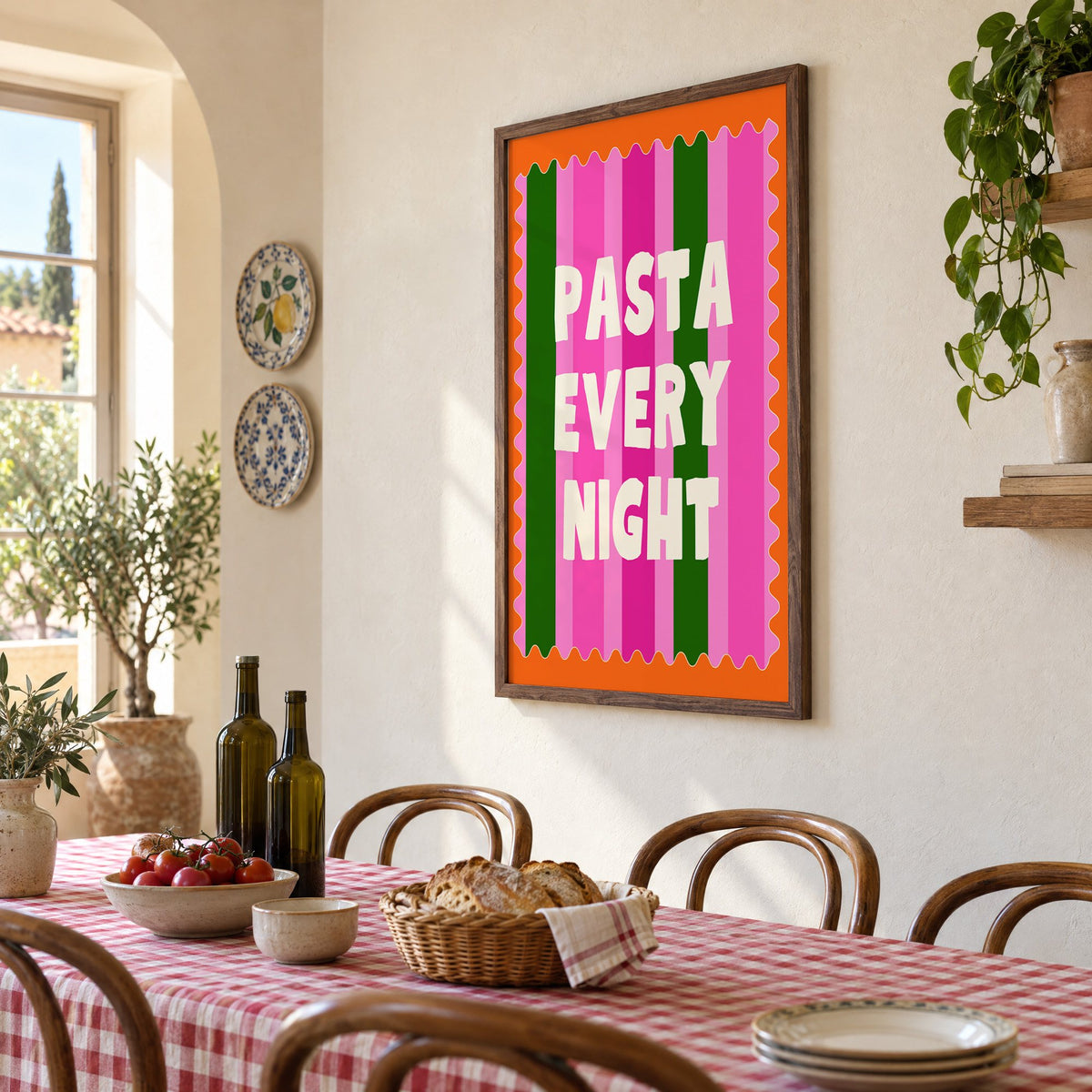 Pasta Every Night pink stripe print in a walnut frame above a gingham-covered trattoria table, seen at an angle