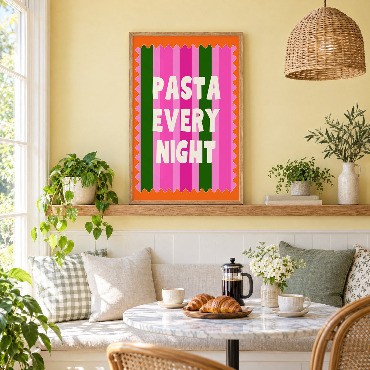 Pasta Every Night pink stripe print in an oak frame on a picture ledge above a sunny breakfast nook