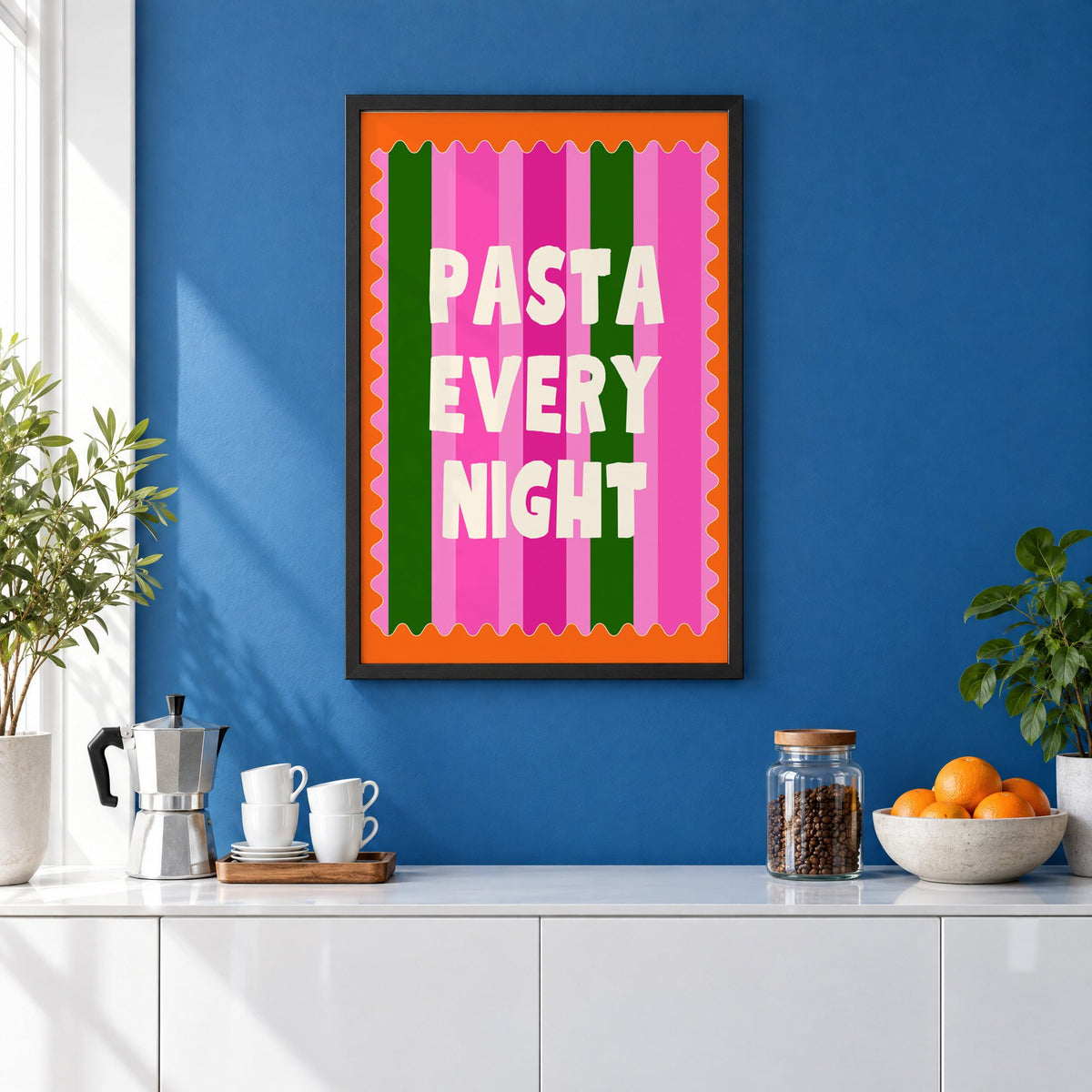 Pasta Every Night pink stripe print in a black frame on a cobalt blue wall above a coffee station