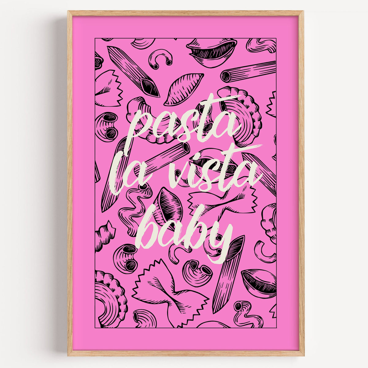 Pasta la vista baby pink print in a light oak frame on a plain white wall