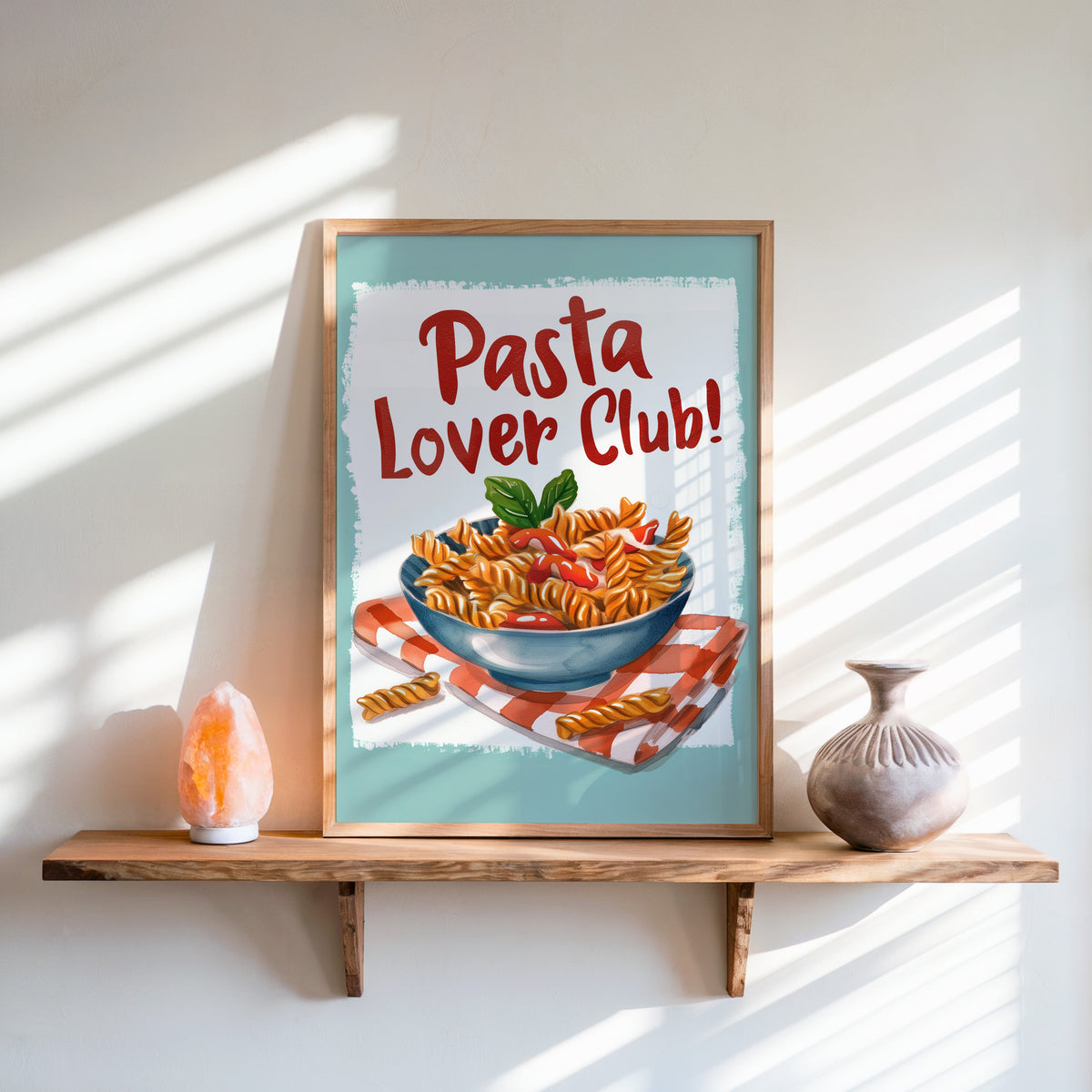 Pasta Lover Club fusilli print in an oak frame on a live-edge shelf beside a salt lamp