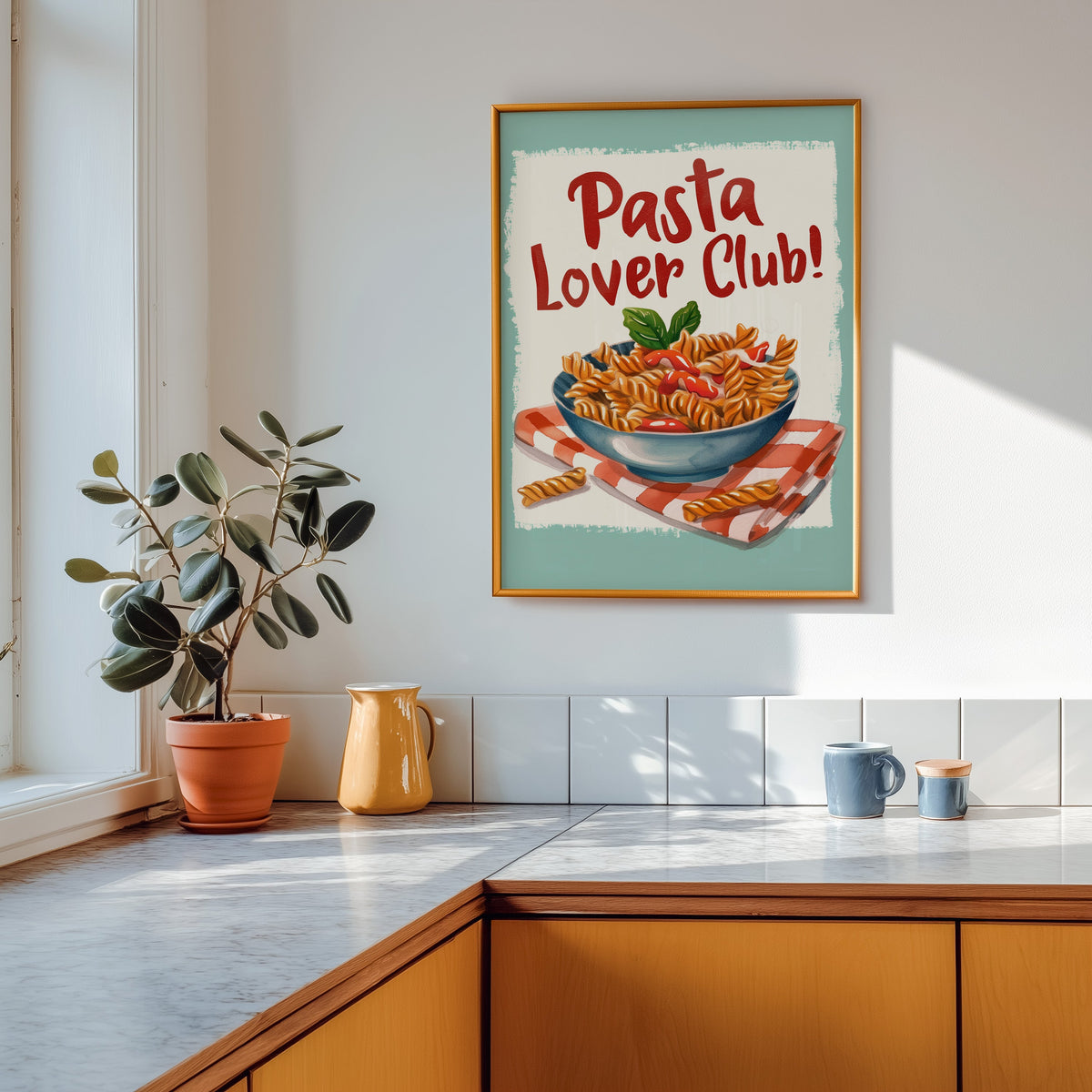 Pasta Lover Club fusilli print shown in a gold frame above a marble counter in a tan kitchen