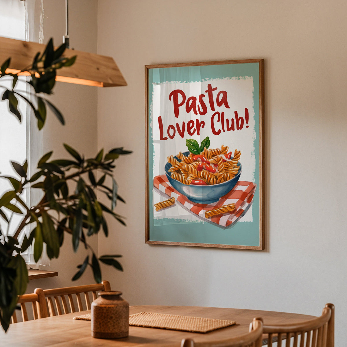 Pasta Lover Club fusilli print in a walnut frame above a dining table with olive branches