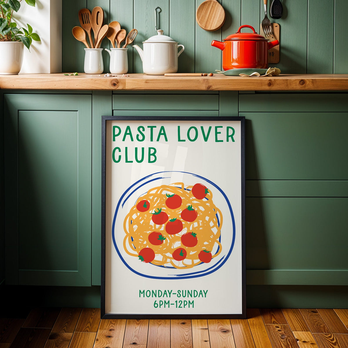 Pasta lover club print in a black frame against sage green kitchen cabinets