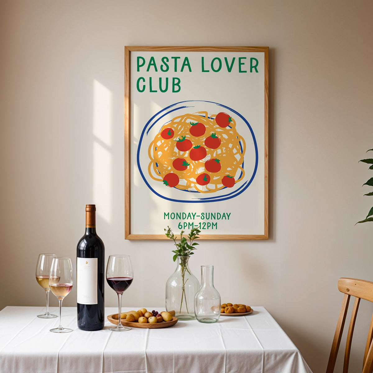 Pasta lover club print in an oak frame above a table laid with red wine and glasses