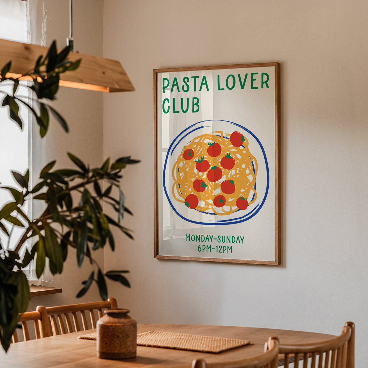 Pasta lover club print in a walnut frame above a dining table beside an olive tree