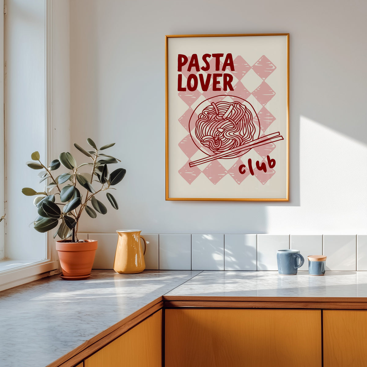Pasta Lover Club print shown in a gold frame above a marble counter with a yellow ceramic jug