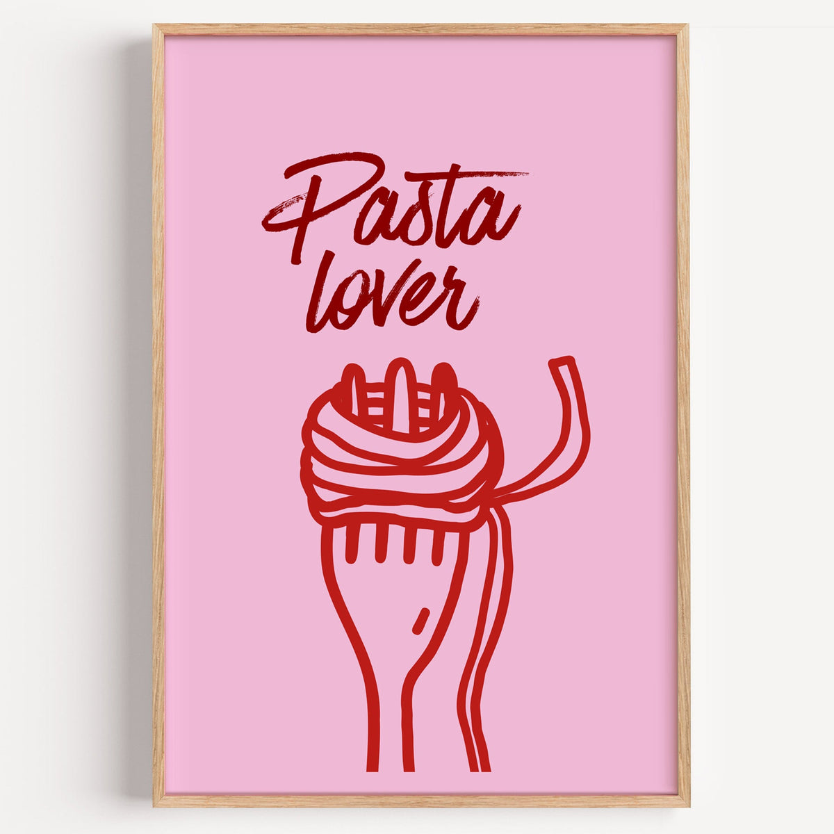 Pasta Lover red fork print in a light oak frame on a plain white wall