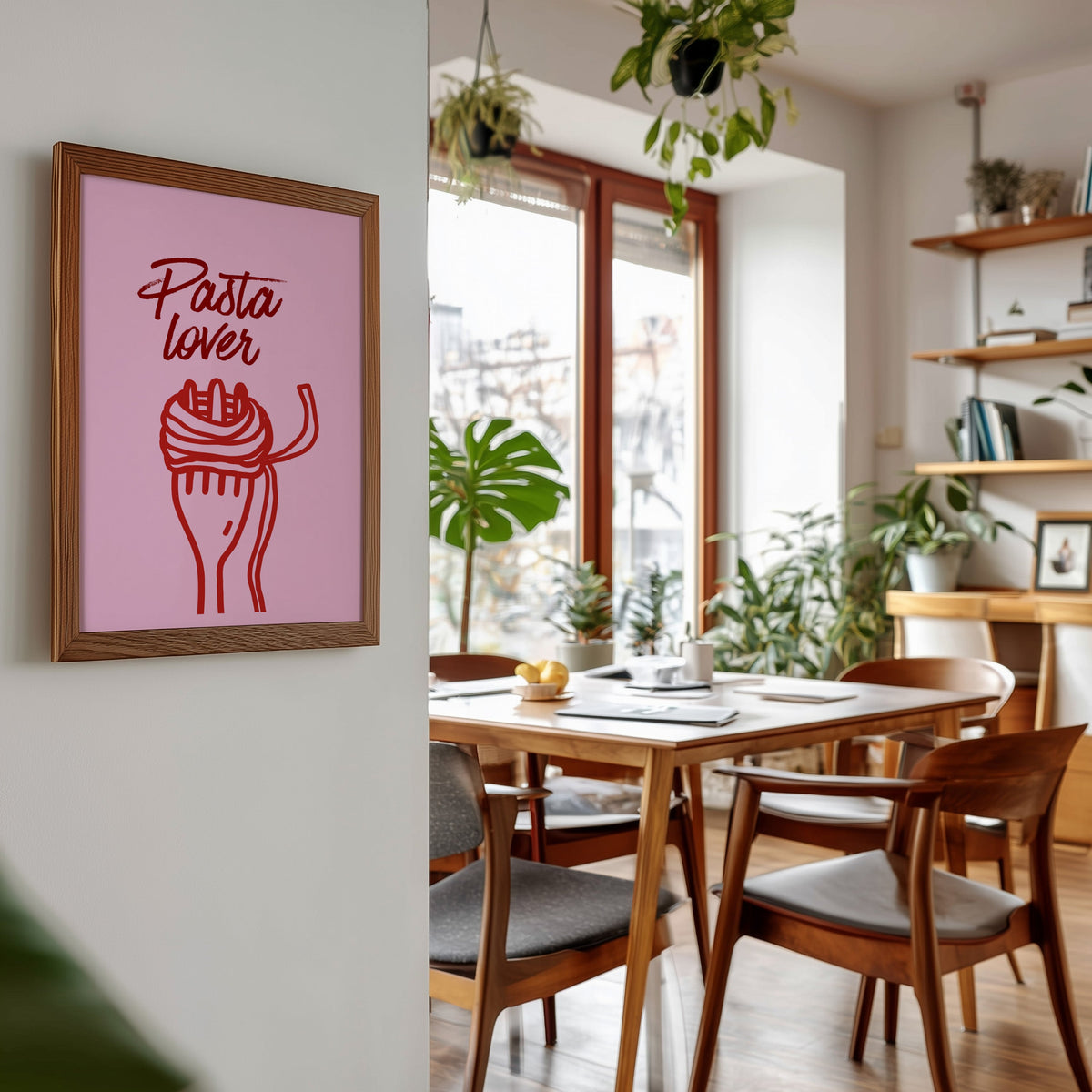Pasta Lover print in a walnut frame beside a mid-century dining table