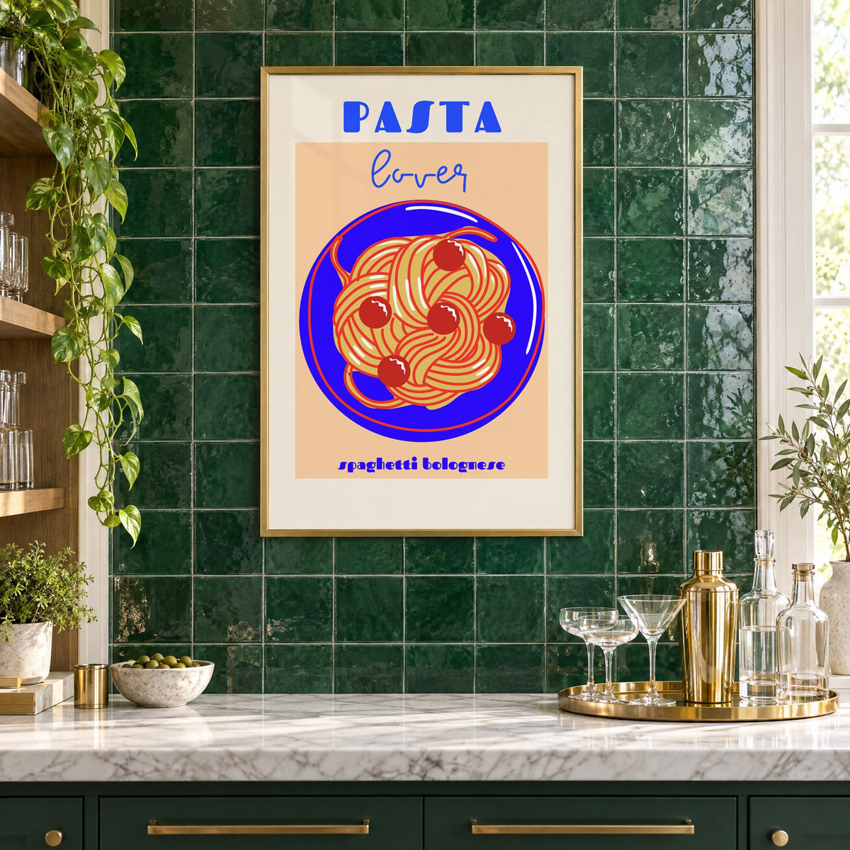 Pasta lover blue plate spaghetti print in a brass frame on emerald green tiles above a home bar with coupe glasses