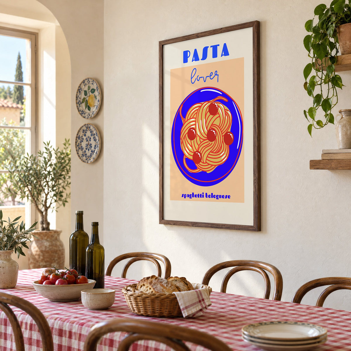 Pasta lover blue plate spaghetti print in a walnut frame above a gingham-covered trattoria table, seen at an angle